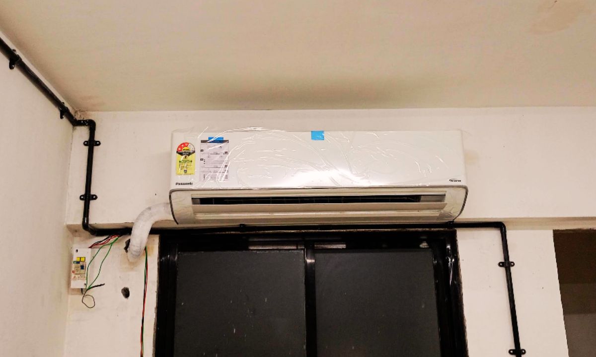 Close view of Panasonic 2 Ton 3 Star split AC indoor unit (CS CU SU24AKY3W) with air outlet flap slightly open for low speed airflow.