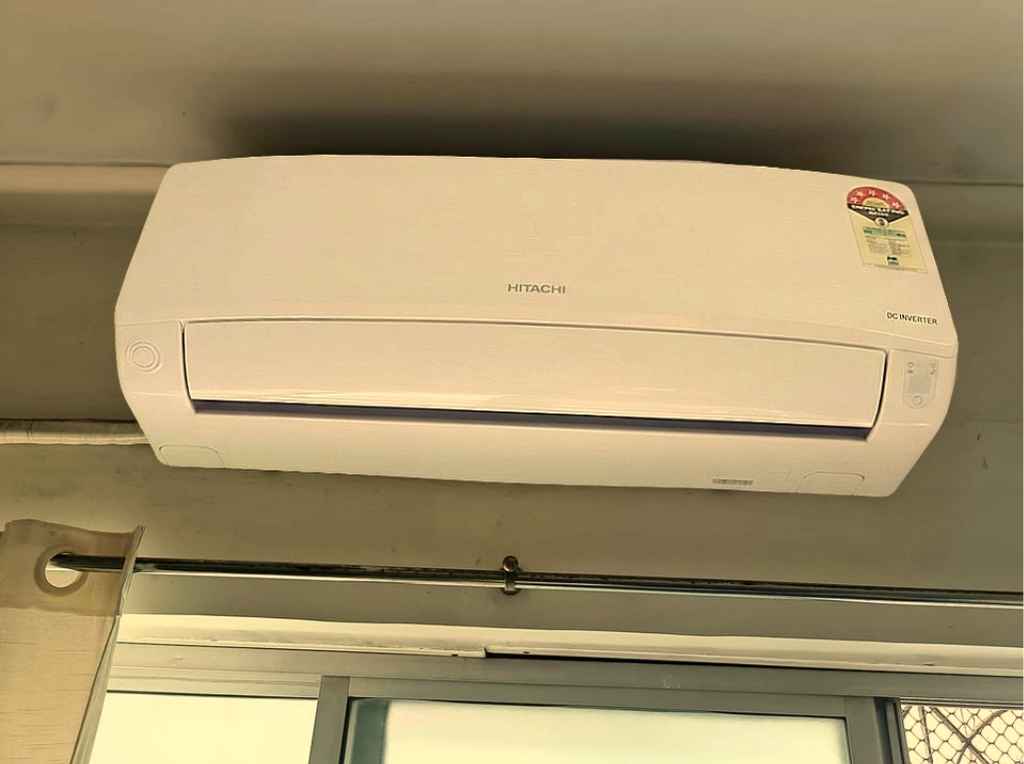 Hitachi 1 Ton Class 5 Star DC Inverter split AC indoor unit wall mounted above a window during installation (5400FXL RAS.G512PCAIBFE)